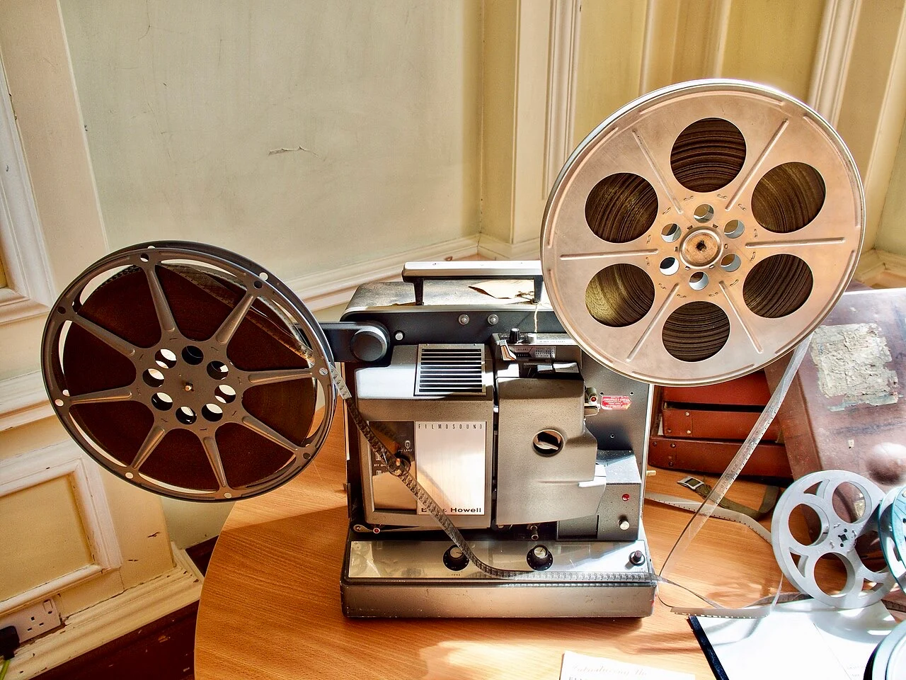 A vintage film projector with two reels